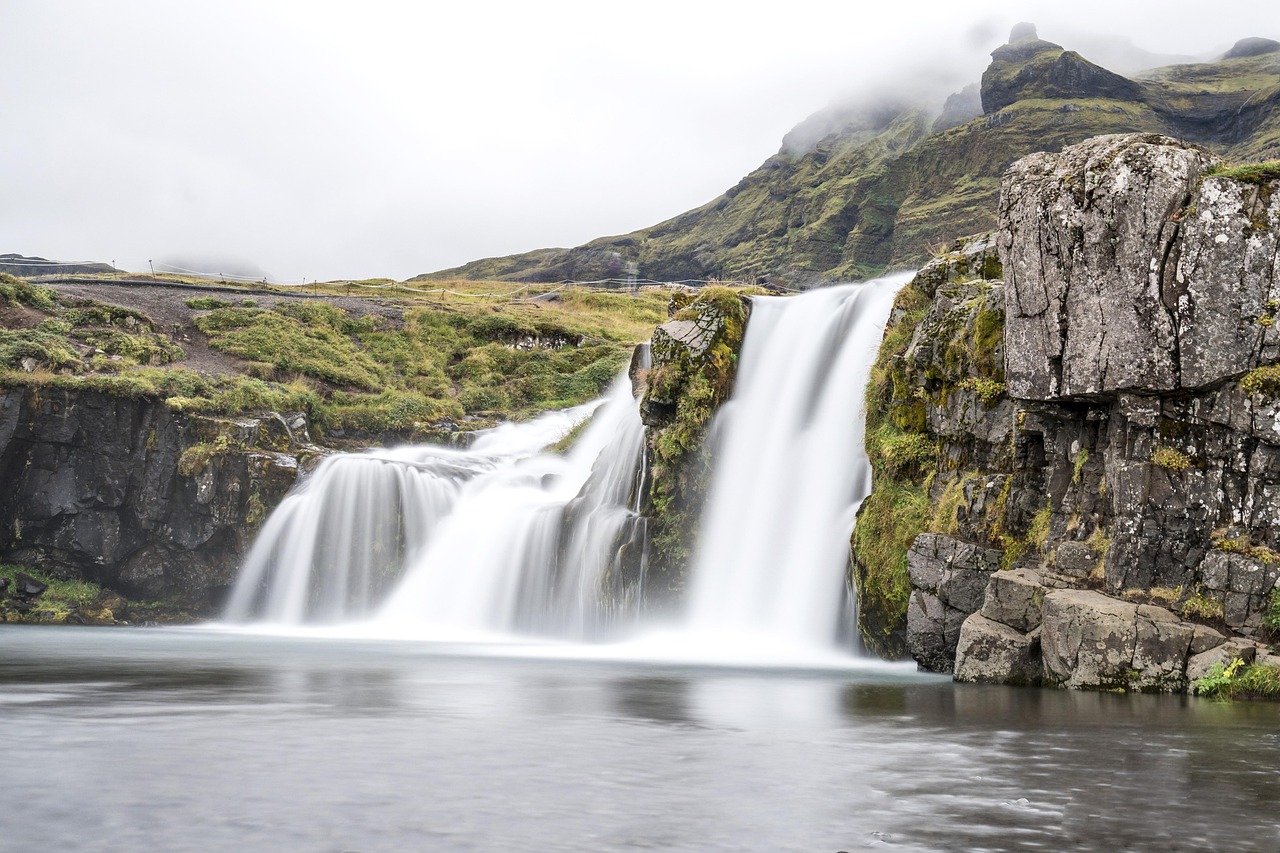 Iceland waterfall and rugged green landscape