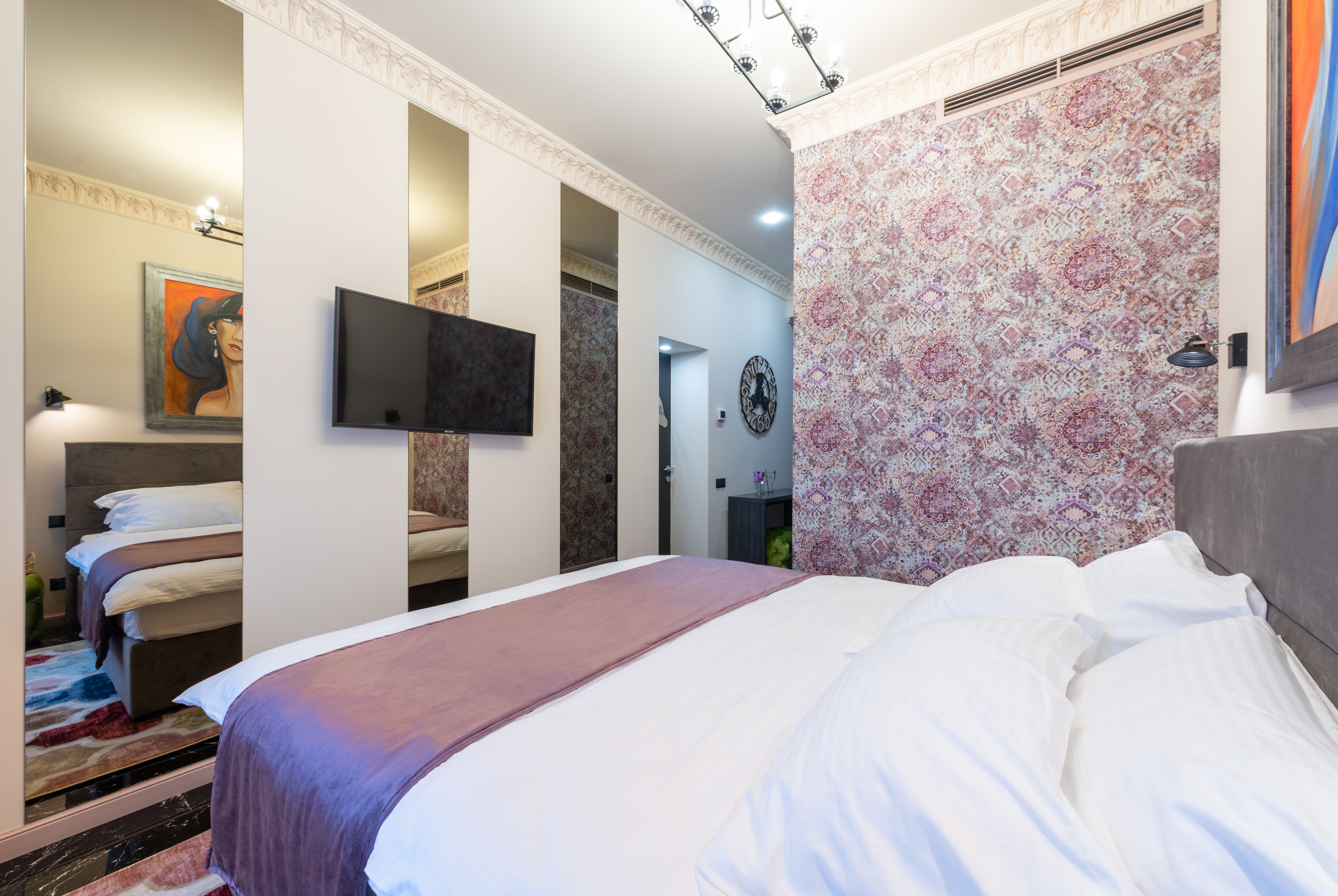 Hotel room with city view and white bedding