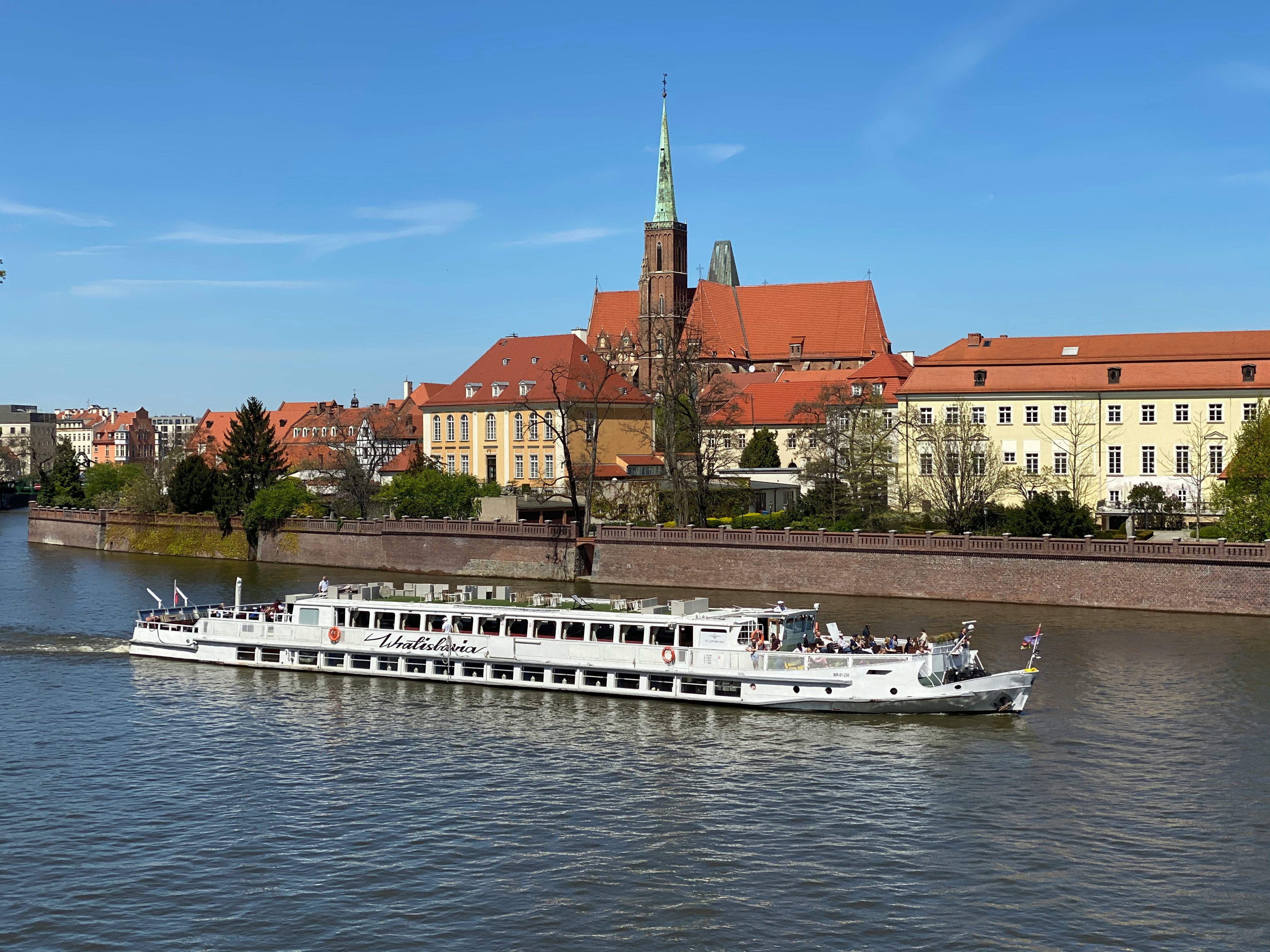 European river cruise ship sailing past scenic riverside views